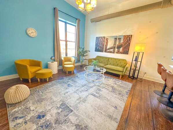 Spacious living room with a lot of natural light and large windows.