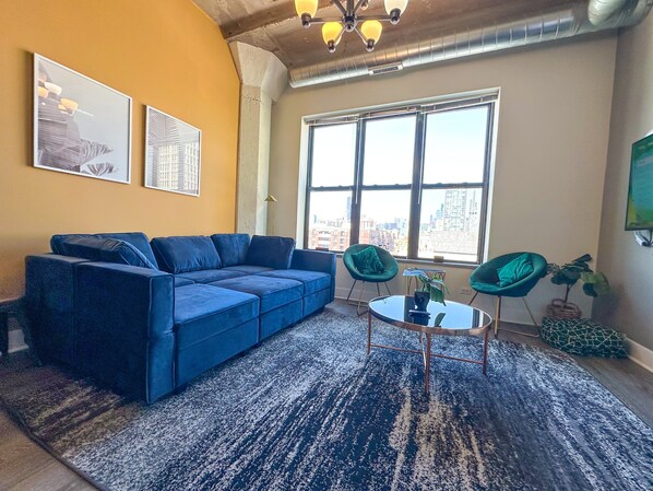 Spacious living room with a lot of natural light and large windows