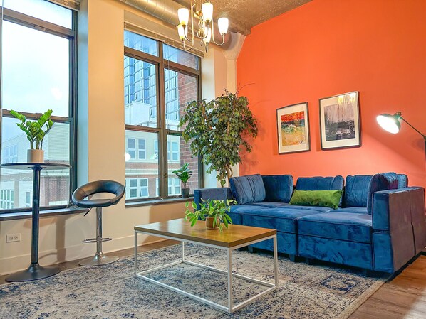Spacious living room with a lot of natural light and large windows.