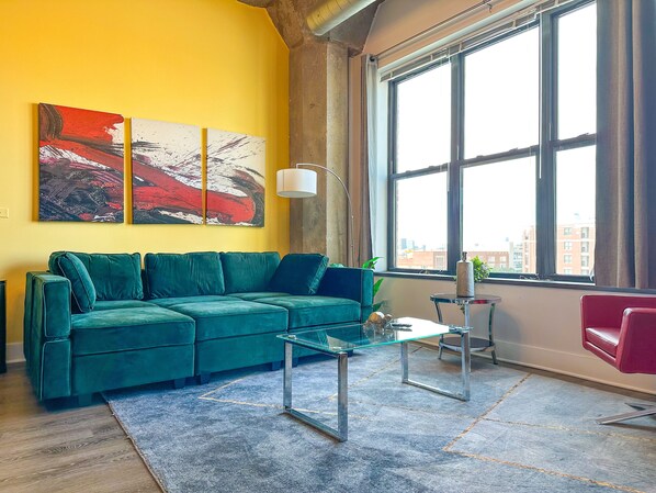 Spacious living room with a lot of daylight and large windows.
