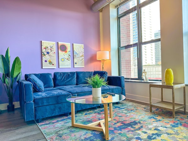 Spacious living room with a lot of natural light and large windows.