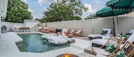 Welcome to our backyard! A heated pool, BBQ, outdoor dining space and lots of spots to lounge.