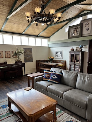 Dining room table.  Living room with piano, TV, games, internet.  