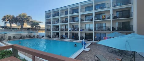 1st floor unit only steps from the heated pool!