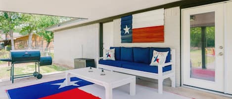 Shaded grilling with comfortable seating ensures no one cooks alone