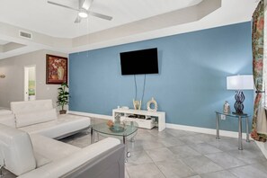 A large Smart TV with HOA provided cable is wall mounted in the main living area.