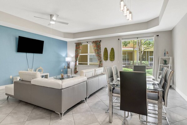 The sliding glass doors open to the screened lanai that runs the full length of the back of the townhome.