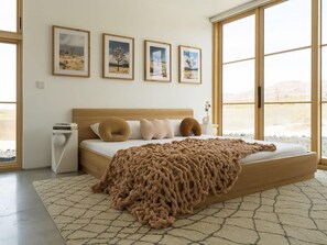 Rest peacefully on the king-sized Layla premium mattress, enveloped in soft linens, and wake up to breathtaking sunrises casting golden hues across the wood-textured exterior. Open the full-sized sliders and step out onto your private paradise!