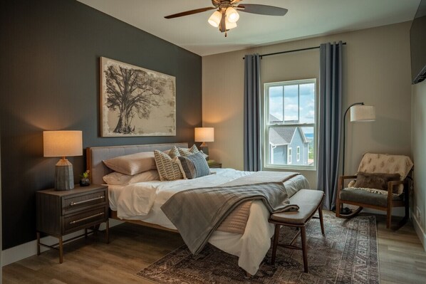 Experience the perfect harmony of retro allure and contemporary comfort as you relax in the cozy queen-sized bed adorned with premium linens.