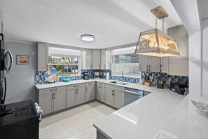 Coastal-inspired kitchen with wraparound counters
