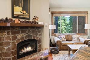 The lovely stone hearth fireplace is centrally located in the main living area so you can keep warm by the fire whether you are eating, cooking, or watching a movie.