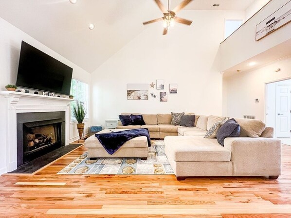 Living space with a huge couch and TV for the whole group to hang out