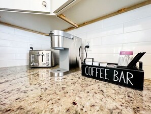 Coffee bar now includes coffe pot, keurig, pods, tea, to-go cups, creamer, and sugar packets!