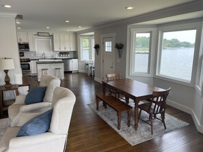 Living & dining room with expansive water views from bay windows