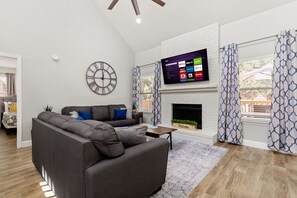 Escape to our stylish living room, featuring an indoor chimney and a TV, where you can cozy up and enjoy a night of relaxation and entertainment