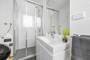 Full bathroom with washer and dryer