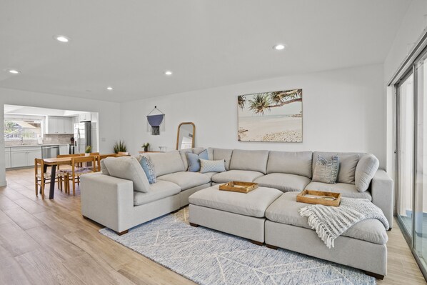 Living Room, Relax on the Large Sectional while watching a movie on the 65 inch tv after a long day at the beach.