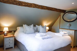 Bedroom one boasts exposed beams and a 5' king-size bed