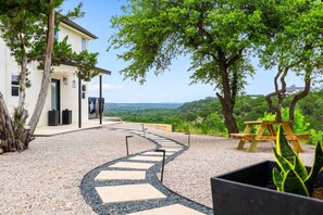The main house and activity space are linked by a graceful path delivering views out to Texas Hill Country.