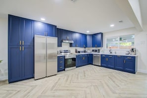 With upgraded unique blue cabinets, stainless steel appliances, and its functional layout, this kitchen is undeniably the heart of the home!