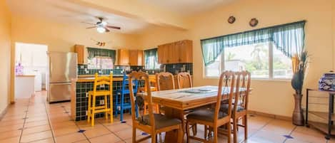 A sun-drenched dining area with a table to accommodate 6 guests