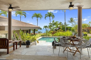 Lanai with pool, hot tub, and glimpses of ocean views