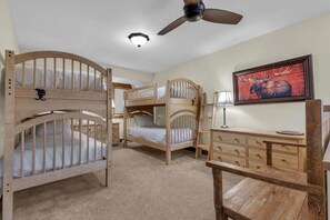 A dynamic loft space great for families and children features two bunk beds all with twin mattresses.