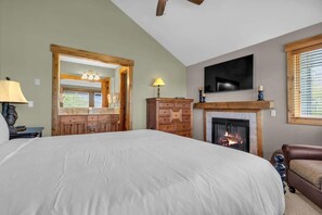 The master bedroom is an elegant space featuring a king-size bed and a fireplace, so you can keep warm and snuggle up in bed while watching the snowfall out your large windows.