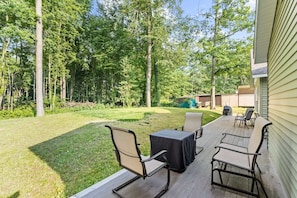 We have plenty of comfy furniture on our back patio, along with a fire table to warm those cool evening gatherings, all ready to be enjoyed against a calming wooded backdrop.