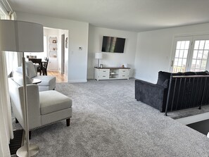 Main living space with view of original hardwood Dining room 