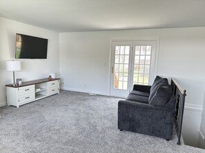Main upstairs living space with view of stairs to basement 
