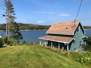 grass slope down to the cottage