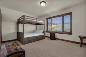 Queen-sized bunk beds offer up a ton of space for members of your group in this downstairs bedroom.