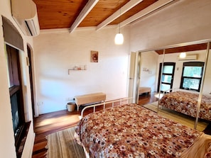 Main bedroom with queen bed, aircon and balcony
