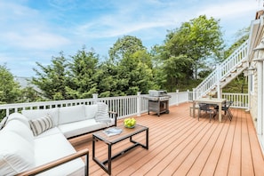 Second story deck w/ outdoor furniture, dining table & BBQ grill