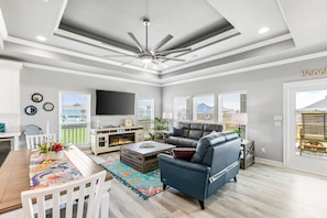 Open living room, dining, kitchen. Enjoy natural light, view and 70" Roku TV.