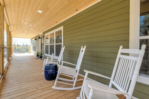 Make memories on the front porch; there are three adult white rocking chairs and one for your little bear. Two cushioned stationary chairs with a table are also on the front porch.