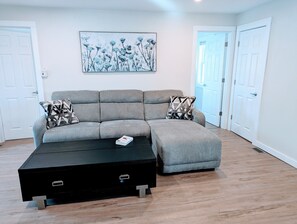 Comfy living space featuring a 50" smart TV and chase sofa recliner.