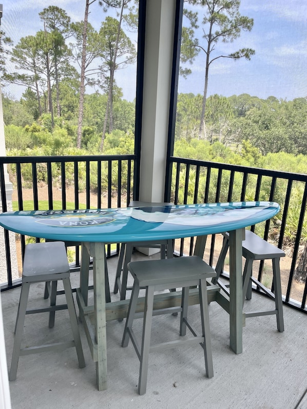 Surfboard table on screened porch