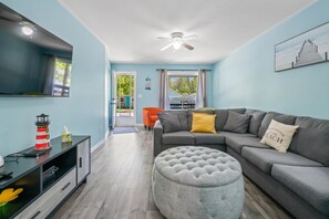 Bright and open living room with 55I flat screen TV