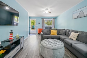 Bright and open living room with 55I flat screen TV