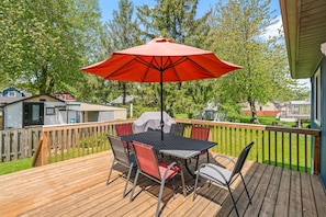 Large west facing deck on the back of the house with outdoor dining area