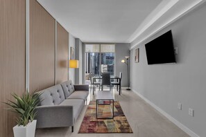 Living room with Sofa Bed, Dining Table and modern Smart TV with apps.