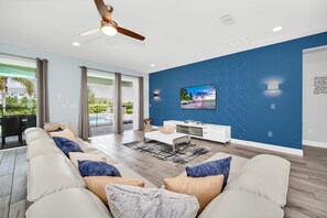 Spacious living room with modern décor and large sectional sofa, ideal for family movie nights or relaxing after a day o
