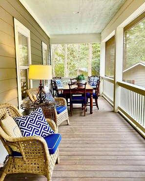 Large porch with dining table and plenty of room for rocking chairs
