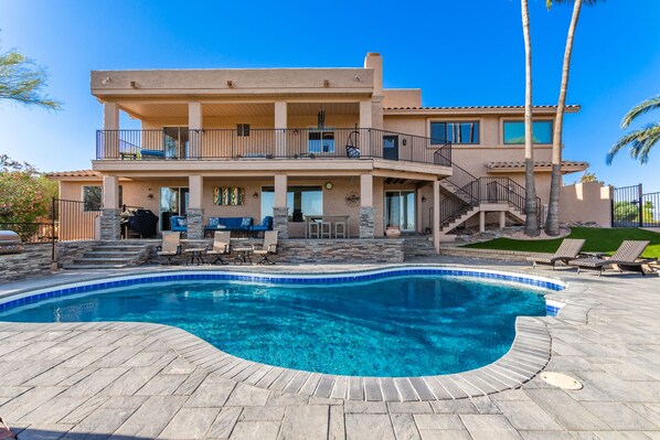 Gorgeous resort-style backyard with sparkling blue pool, spa and lounge chairs. 