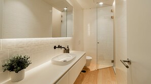 Start your day refreshed in this sleek bathroom boasting a large shower and modern fixtures. #bathroom #modern