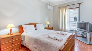 Sleep well in this comfortable bedroom, with a cozy queen bed, AC, and TV. #portugal #pt #algarve # comfy #comfortable