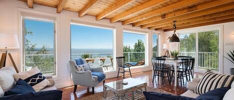 Living room and dining area with large windows