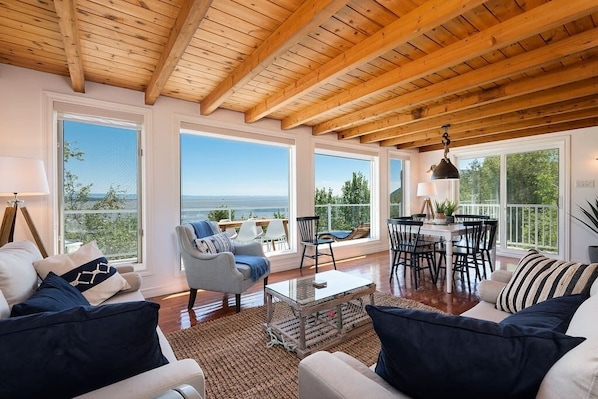 Living room and dining area with large windows